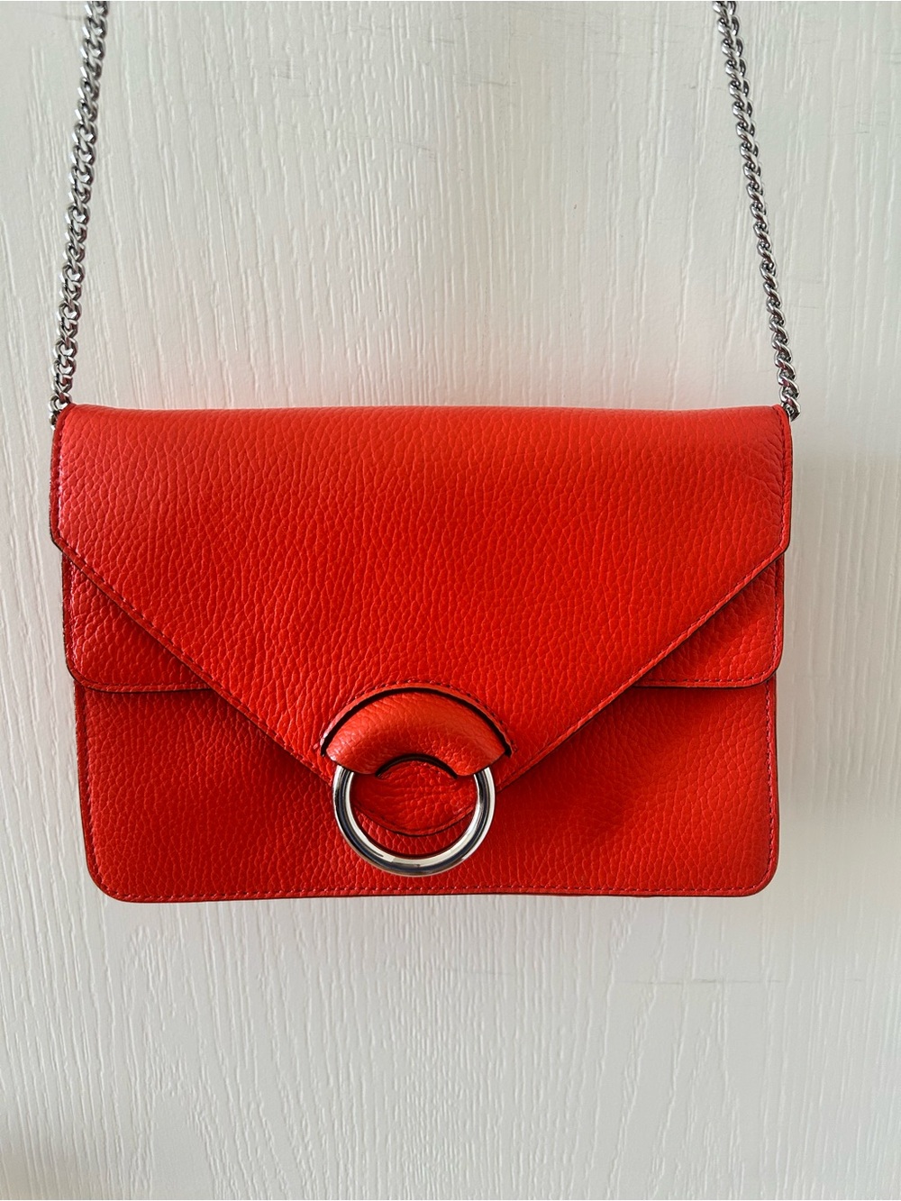 Vibrant Orange Leather Shoulder Bag with Silver Ring Accent & Chain Strap